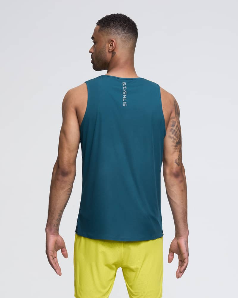 Back of a male runner in a teal and yellow Dæhlie Singlet Run 365, showing the athletic fit and breathable mesh.