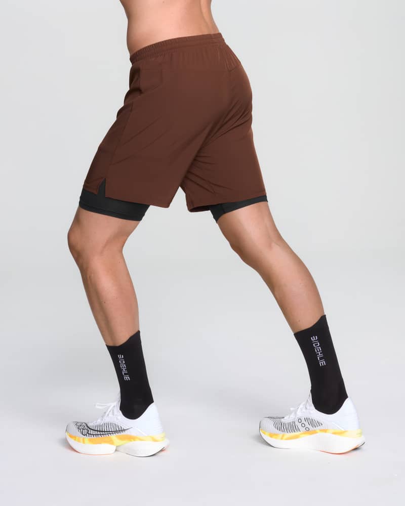 Back angle of a runner wearing Dæhlie's brown 2-in-1 shorts with comfortable flatlock seams.