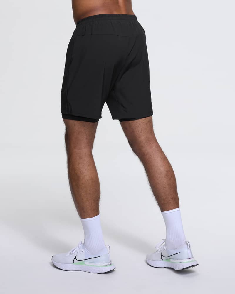 Back view of a runner in Dæhlie's black 2-in-1 shorts, a basic for everyday training sessions.