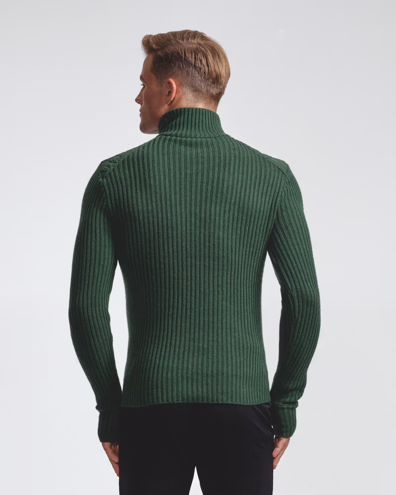 Man in the green Half Zip Comfy 2.0 men's sweater, showing the stitchless ultrasonic quilted front panel.