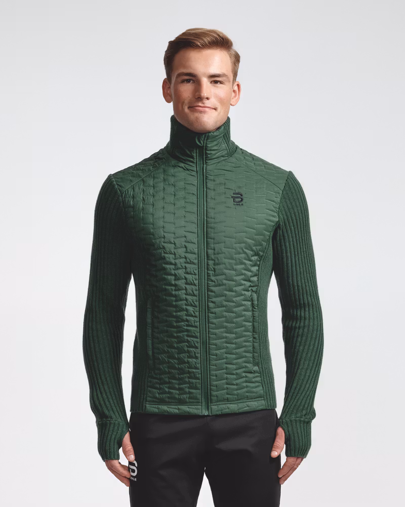 Man in the green Full Zip Comfy men's jacket, featuring stitchless ultrasonic quilting for wind resistance.