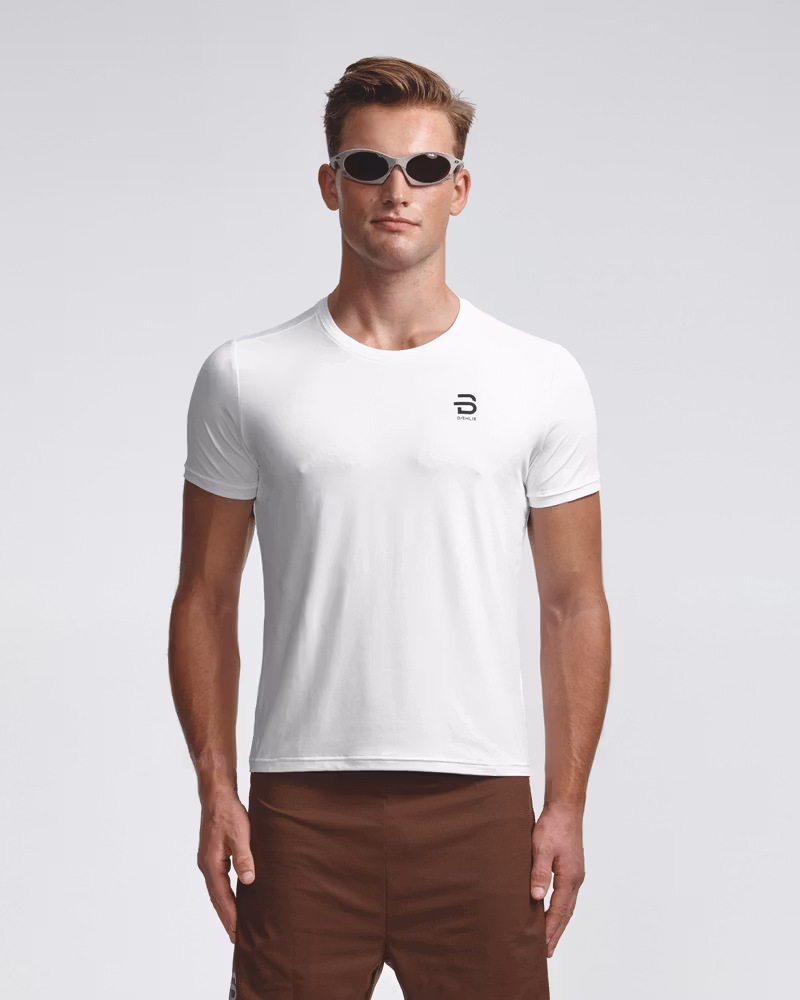 Dæhlie male model wearing white logo t-shirt with sunglasses, front view.