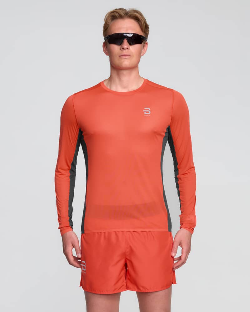 Man wearing the red and black Dæhlie Long Sleeve Air, a technical shirt designed for high-output training sessions.