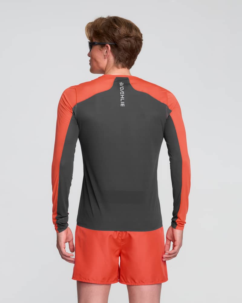 Back view of a man in the red and black Dæhlie Long Sleeve Air, showing the integrated 37.5® technology in high-sweat zones.