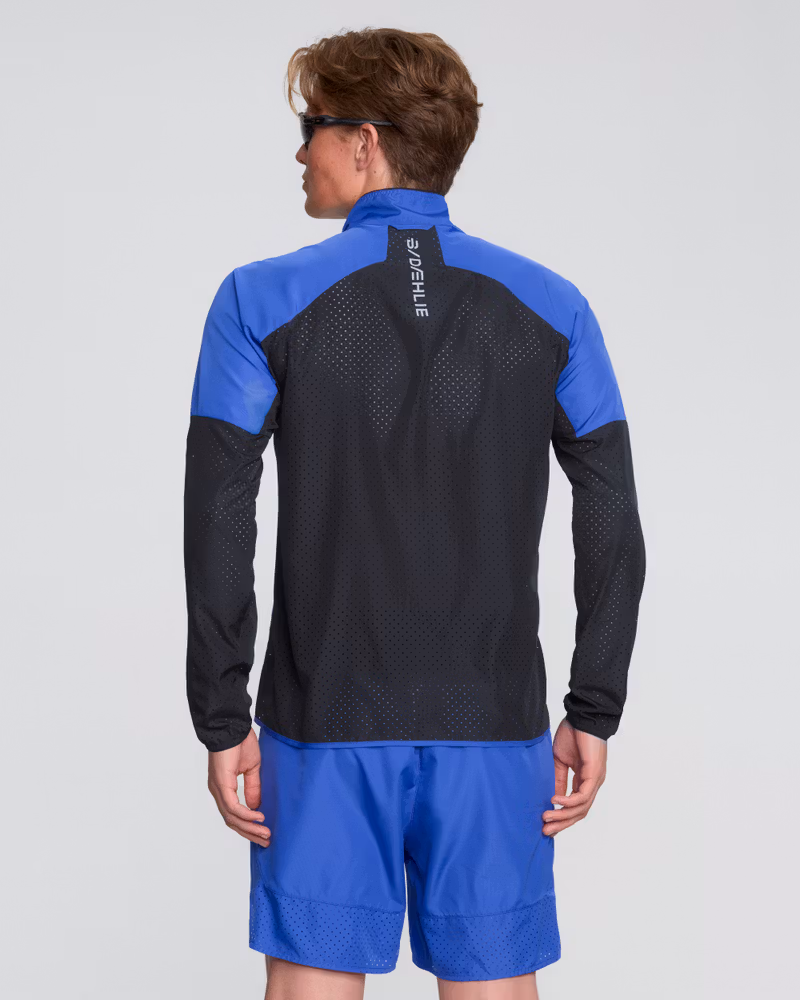 Back view of a man wearing the blue and black Dæhlie Jacket Air, showing its active fit for freedom of movement.