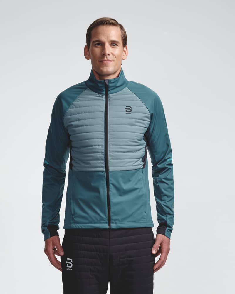 Teal men's Jacket Challenge 3.0, front view on model for high-intensity cross-country skiing.