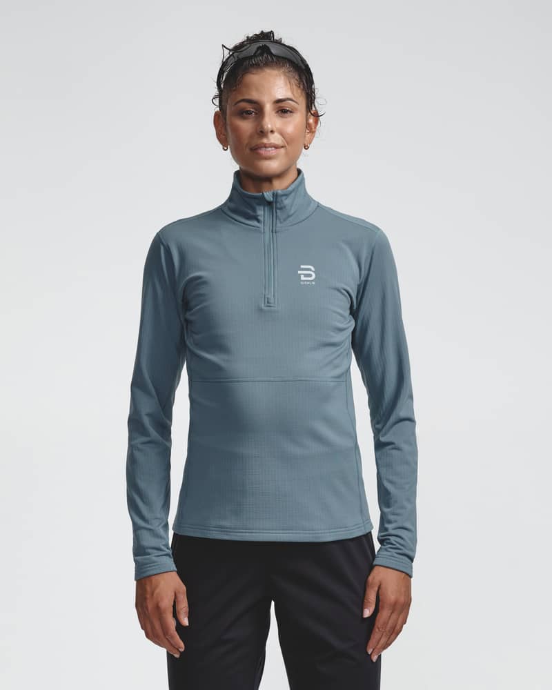 Blue-gray ribbed half-zip midlayer top, front view on model