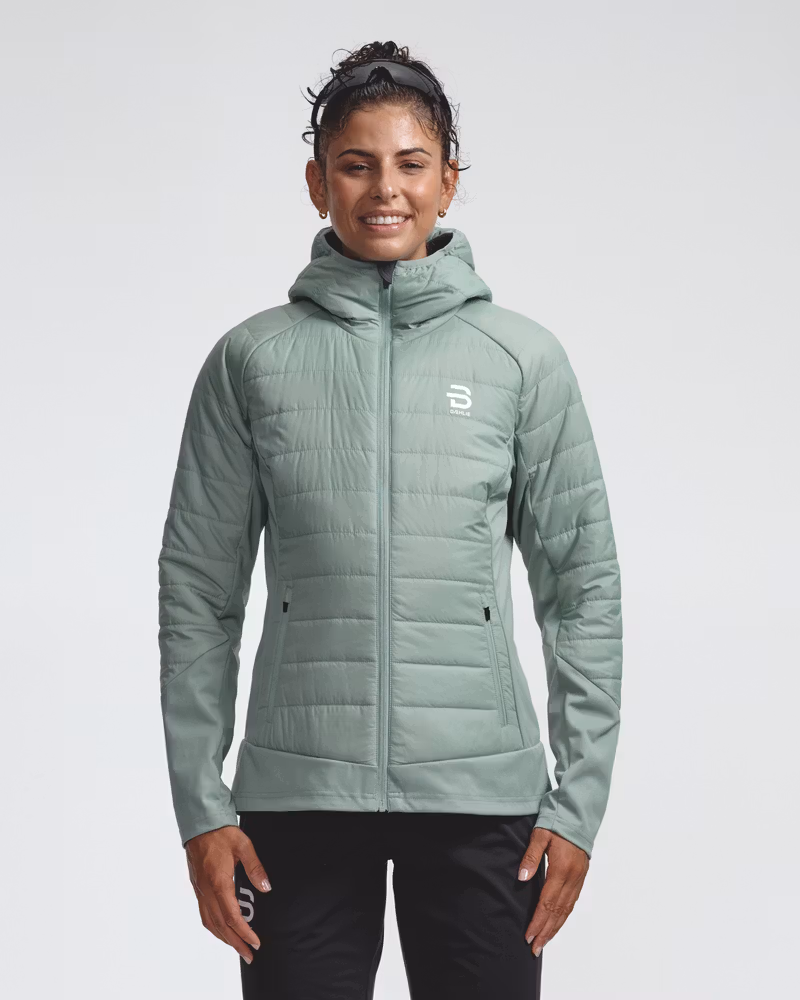Sage green quilted hooded jacket, front view on model, zipped up