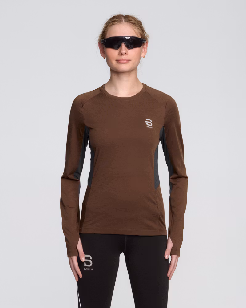 Female runner in Dæhlie's brown Long Sleeve Tech Wool, a performance top for high and low-intensity efforts.