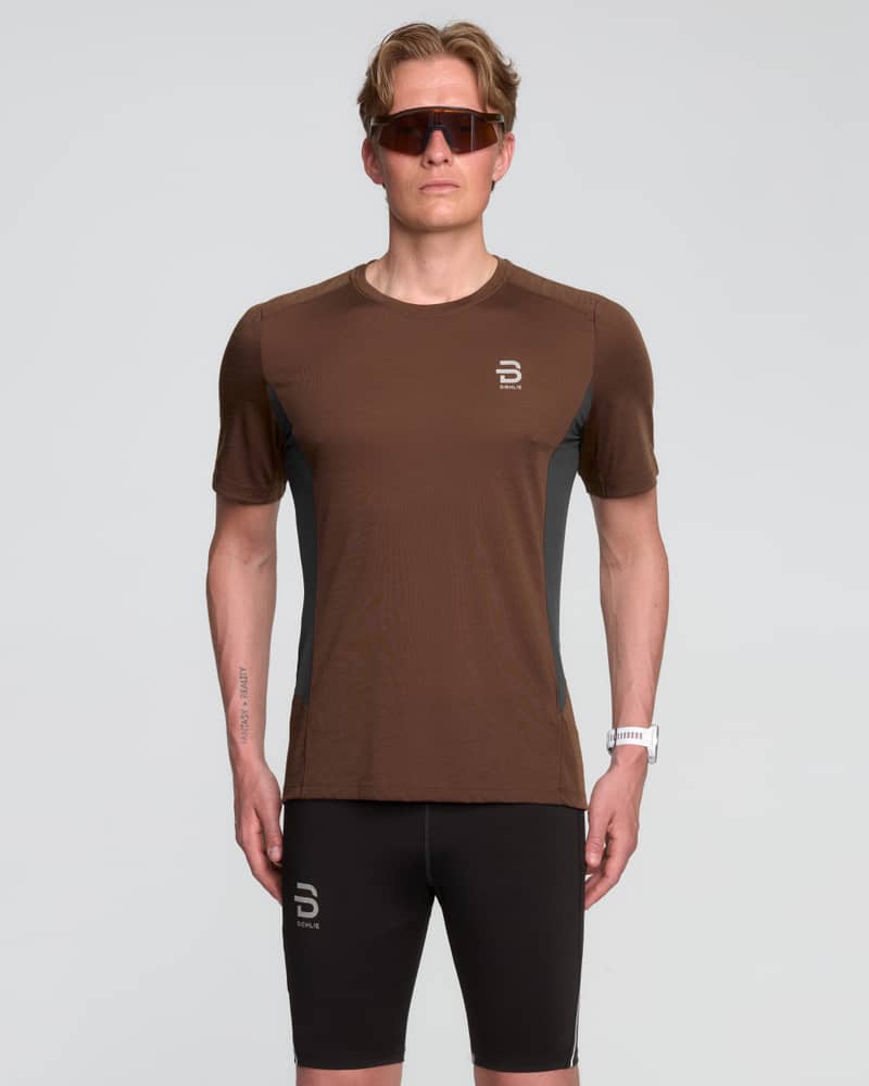 Male runner wearing Dæhlie's brown T-Shirt Tech Wool, designed for optimal climate control during runs.