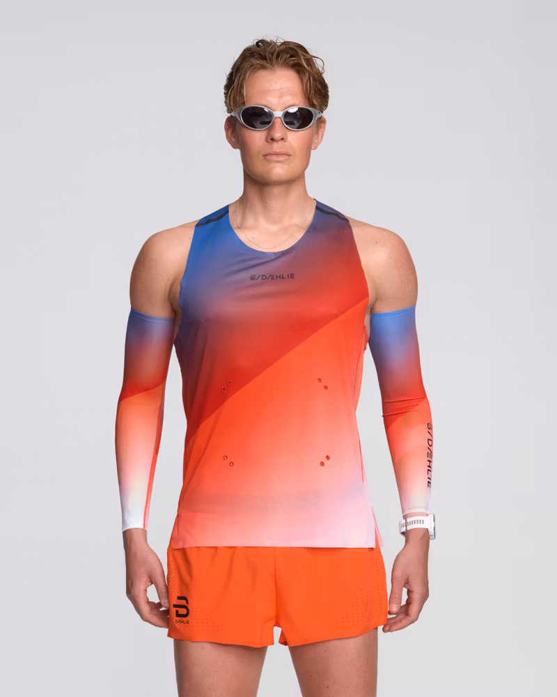 Male runner wearing the Dæhlie Elite Air singlet in a colorful gradient, designed for high-speed racing.