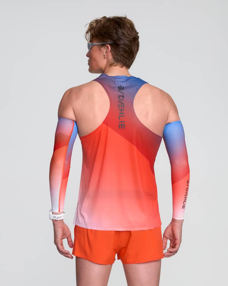 Back view of a runner in a Dæhlie gradient singlet, showcasing the breathable racerback and taped seams