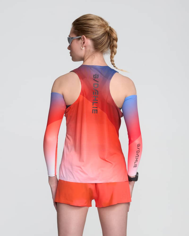 Rear view of a female runner in the Dæhlie gradient singlet, designed with a racerback for optimal arm movement.