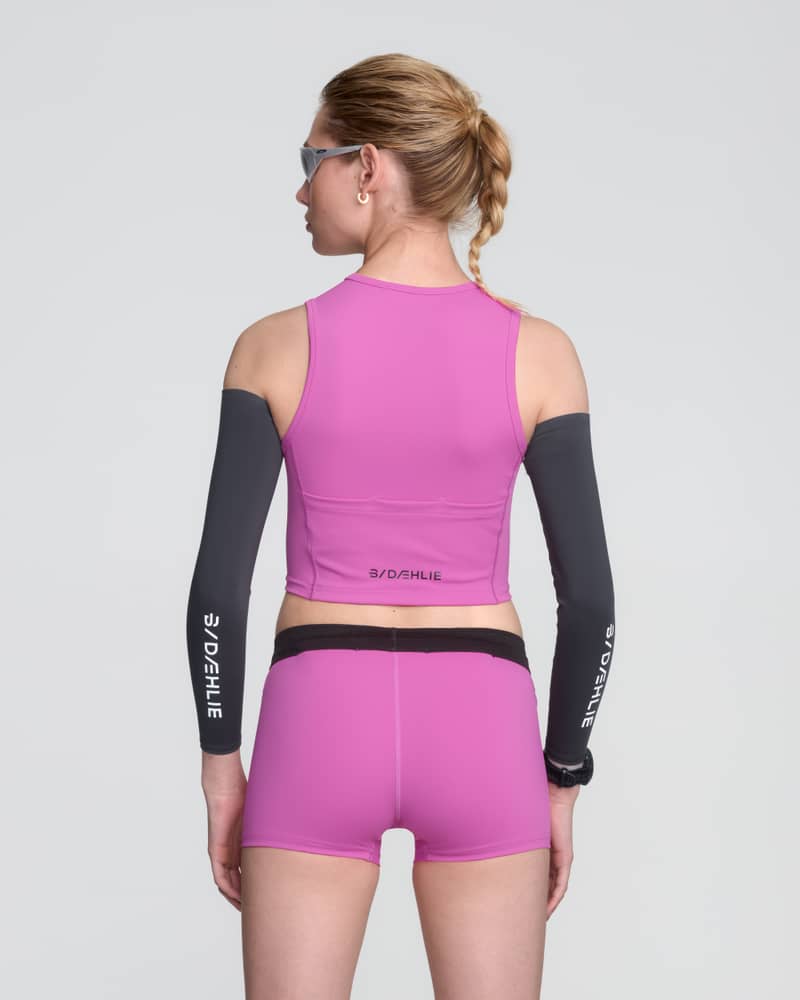 Back view of a runner in a pink Dæhlie Top Elite, showing the racerback design for freedom of movement.