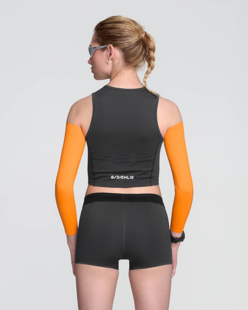 Back view of the Dæhlie black Top Elite on a runner, highlighting the integrated waistband for a secure fit.