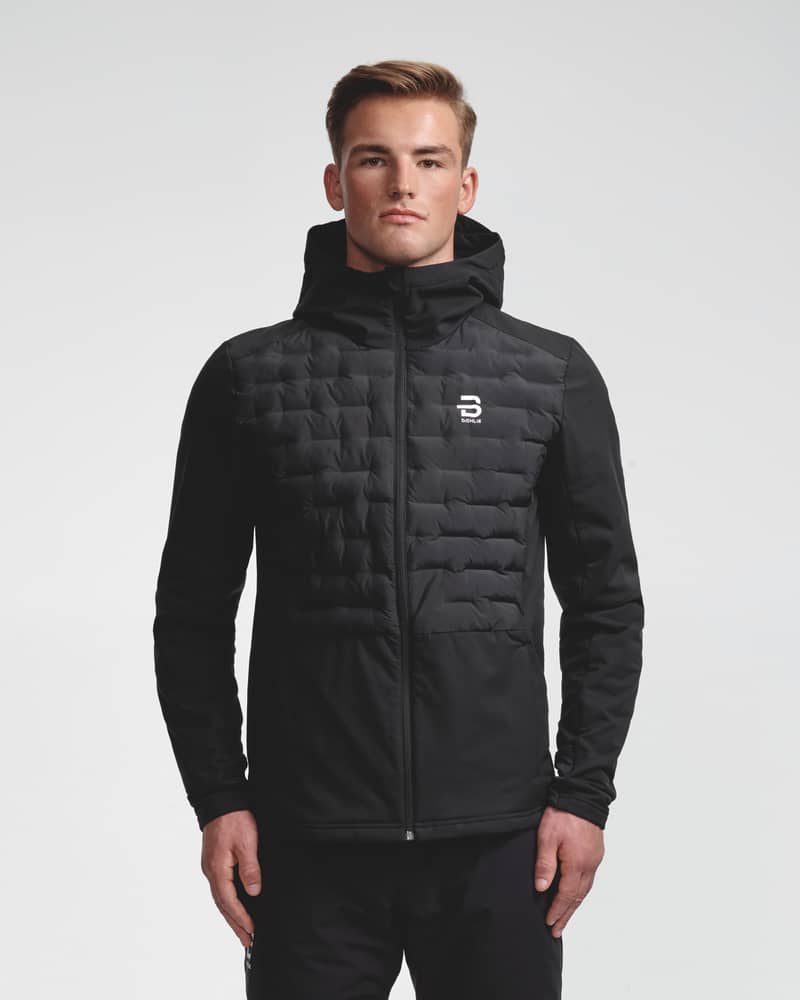 Black quilted hooded jacket with hood up, front view on model, zipped up