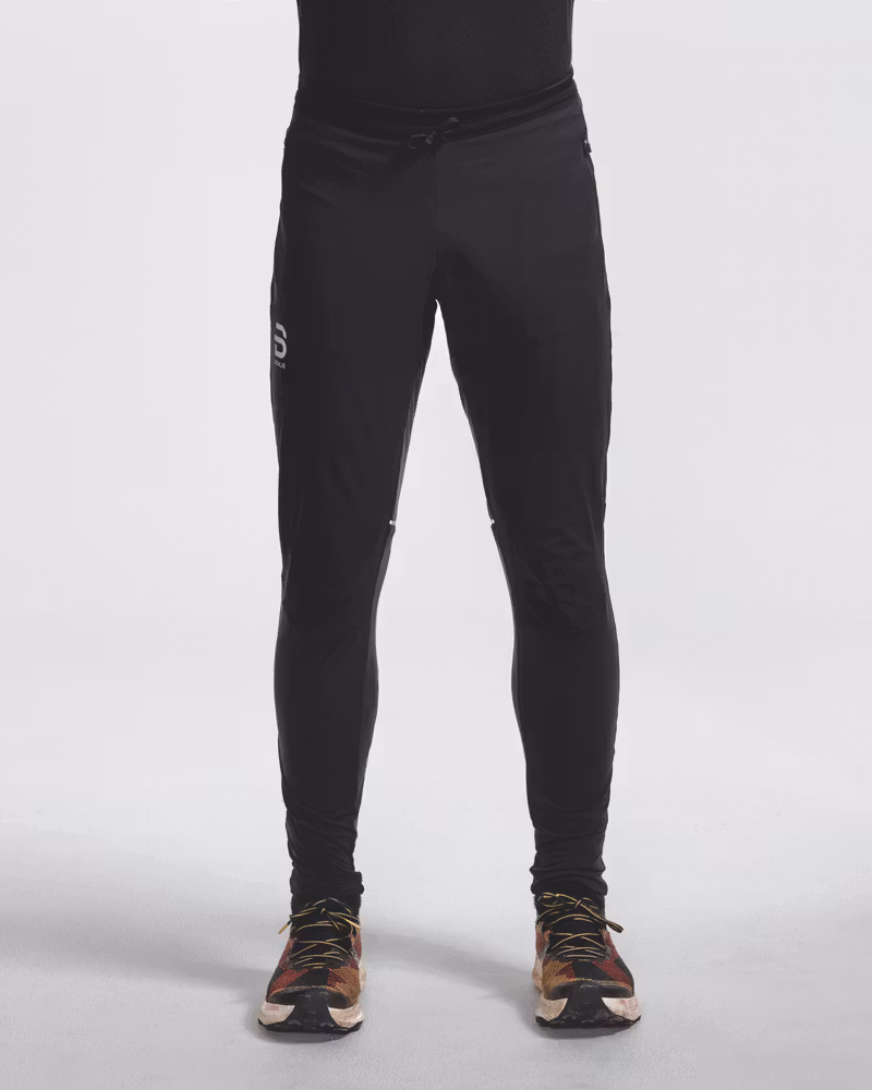 Front view of legs wearing black Dæhlie running tights with running shoes.