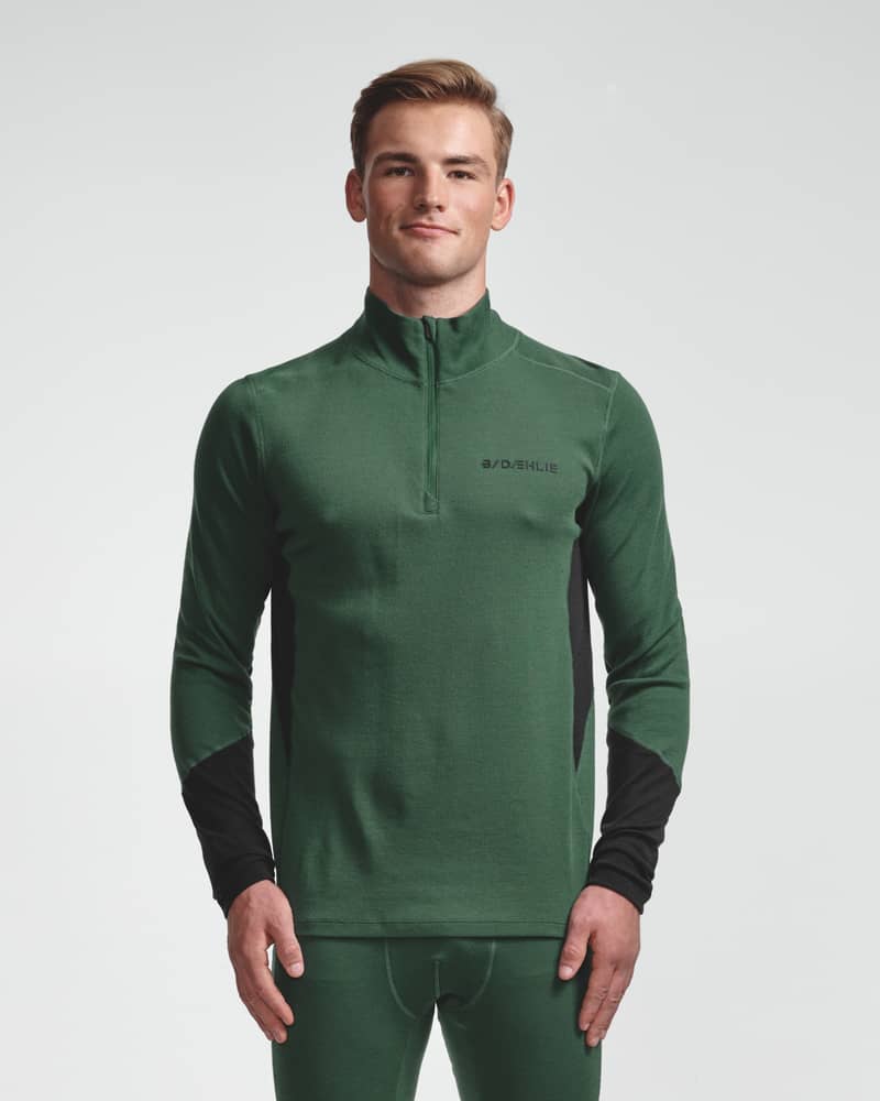 Dæhlie green half-zip baselayer top and matching leggings on male model, front view