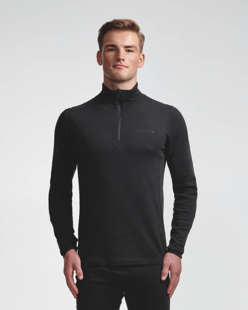 Dæhlie black half-zip baselayer top and matching leggings on male model, front view