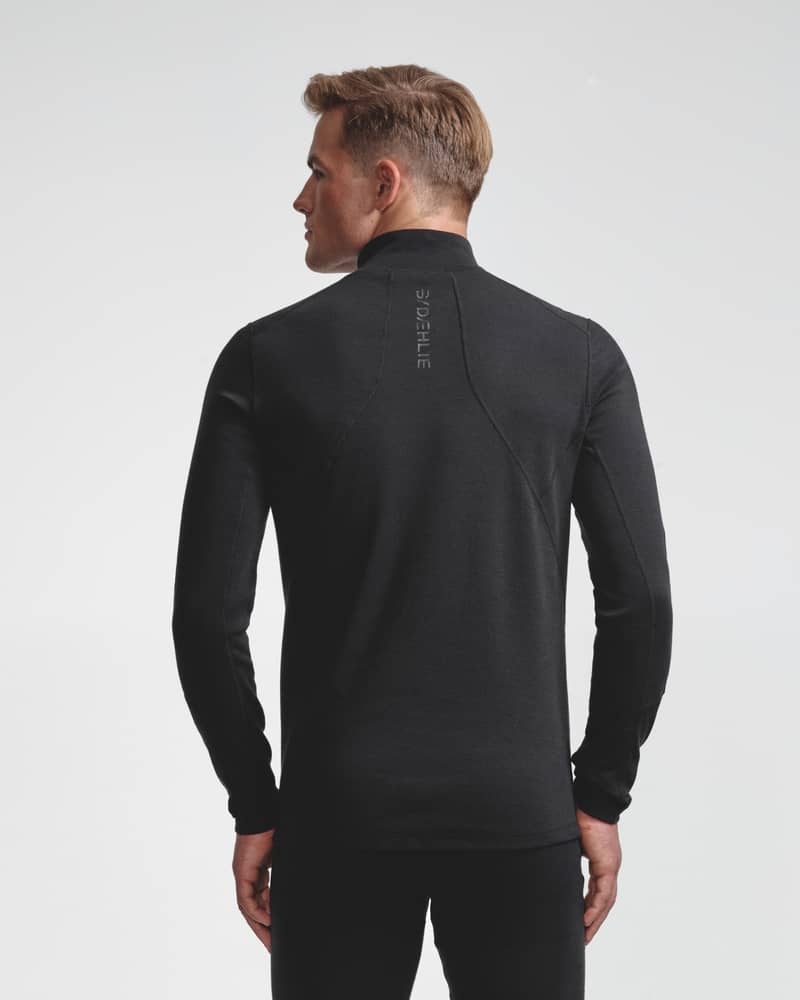 Dæhlie black half-zip baselayer top and matching leggings on male model, back view